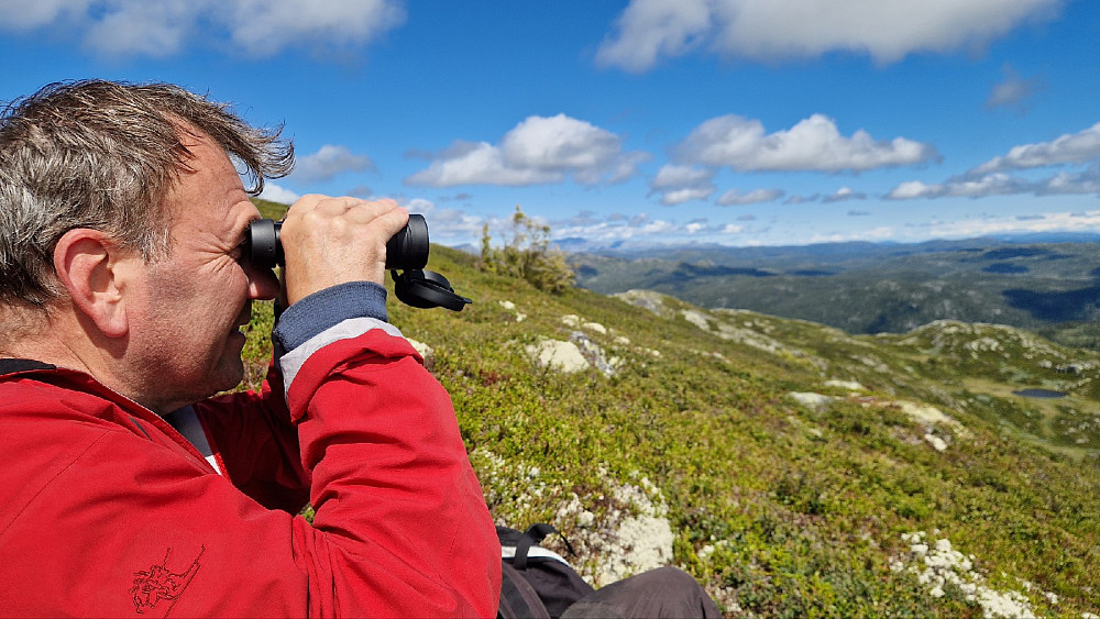 I le litt under toppen ble det litt kikring før kursen ble satt mot en enda lunere rasteplass. Vi ser fjellene ved hytta vår midt i bildet. Det er på andre siden av Åmotsdalen. Helt bakerst troner Blefjell.