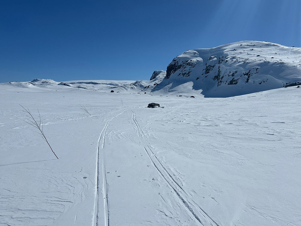 På vestsiden av et av Kyrkjedørsvatni (1405 moh) kan jeg skimte flate Hallingskarvet og turmålene mine Ljøtebotnberget og begge Simlenutane til høyre.