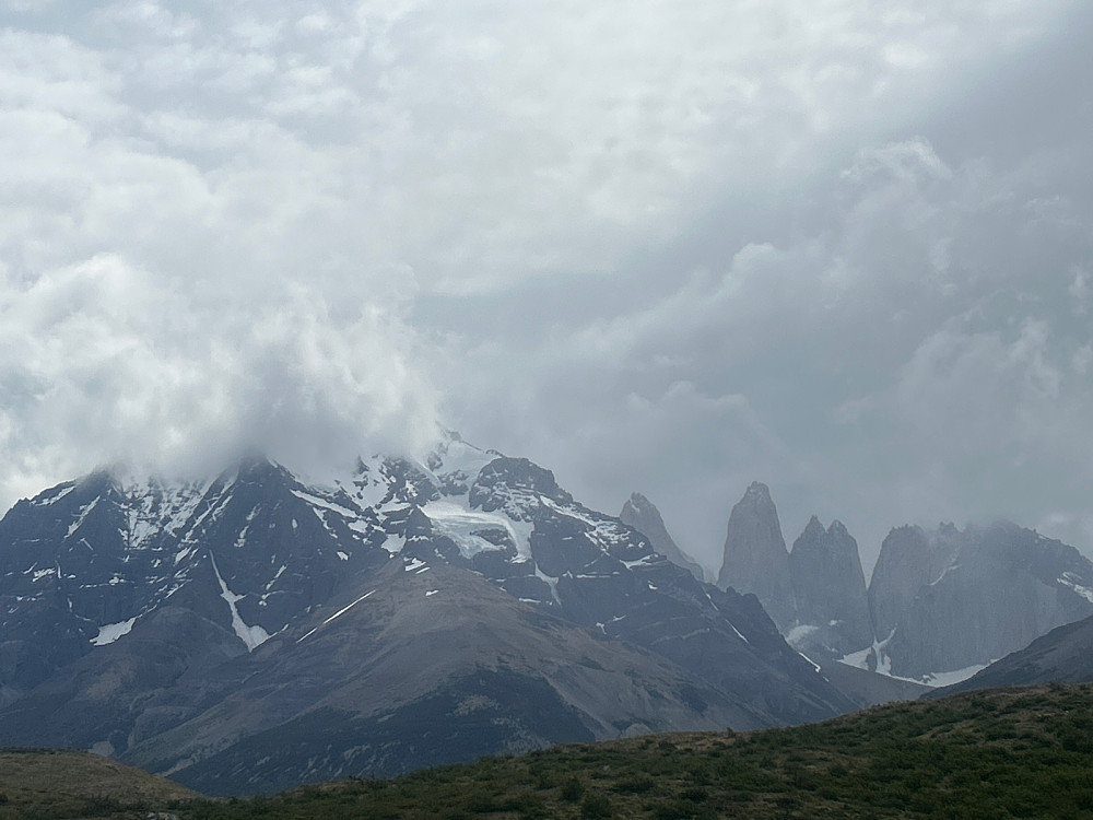 Monte Almirante Nieto på 2640 moh er dekket av skyer, mens de tre tårnene som har gitt Torres del Paine sitt navn kan likevel ses i lett regnvær.