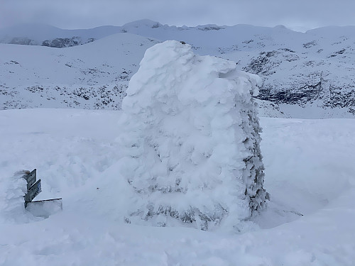 Image #8: The cairn on top of Mount Høgenibba. Due to recent snow in windy weather, it was completely covered by snow on some of its sides.