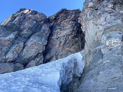 Image #4: Entrance to the crevice that separates Mount Store Trolltind from Mount Vestre Trolltind. The ice and hard packed snow in the chute is part of Adelsbreen Glacier.