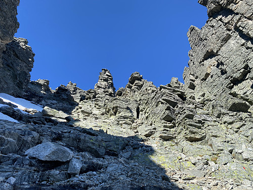 Image #25: Looking upwards a chute leading up to the summit of Mount Store Trolltinden. This is where I encountered the regular route most commonly used to climb Mount Store Trolltinden. A little red dot may be seen on a stone in the lower right corner of the image; and this is  one of a trail of red dots that marks out the route to the summit of the mountain.