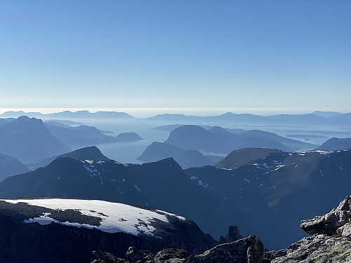 Image #31: View from Mount Store Trolltinden towards the fjord of Romsdalsfjorden. The snowcapped mountain nearby is Mount Trollklørn, which I had just ascended, and the mountain ridge behind it is the Isterdalen Mountain range, which I trekked the entire length of about a year ago.