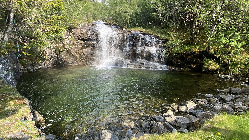 Image #14: Just a few meters from Lundeplassen parking lot is a pond in Skardselva River, with a beautiful waterfall dropping directly into it. At this spot it is possible to cool yourself in hot weather, and even to have a swim, should you so desire.