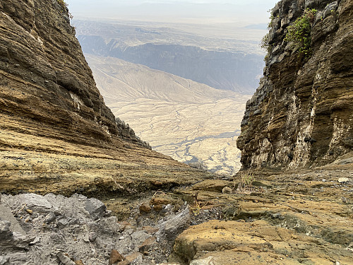 Image #34: The plains below are just as fascinating as the rock formations up here; the rocks being formed mainly of solidified lava. Down there somewhere, our safari Landcruiser and our driver are waiting for us.