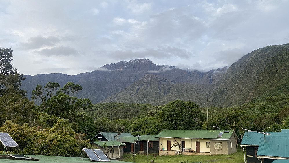 Image #20: The view from the dining hall tower towards the summit of Mount Meru. The Meru Ash Cone is seen just in front of the mountain.