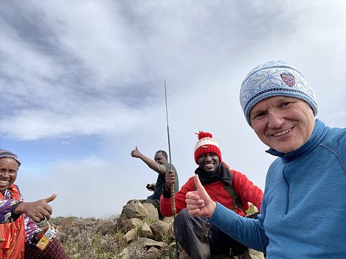 Image #22: Enjoying a short break at the summit, our local guide Makamero, our ranger Olais, Frank and myself.