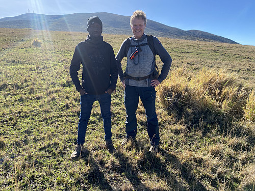 Image #10: Myself and Frank standing at the same point. Mount Oldeani is seen in the background. We were of course quite disappointed that we weren't allowed to summit the mountain on this occasion, but we tried to keep our spirits up.