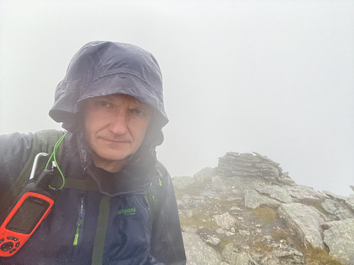 Bilde #34: Ved varden på toppen av Storknubben [1208 m.o.h.]. Nå var det begynt å regne, hvilket jeg var glad det ikke gjorde under traverseringen rett før.