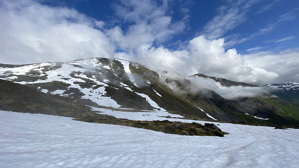 Bilde #5: Forholdene skiftet en hel del under denne turen. Her har skydekket sprukket opp en del, og vi ser Storbua [1498 m.o.h.] til venstre, og Dyrdalstinden [1371 m.o.h.] lengre til høyre. Mellom dem ligger også Månvasstinden [1467 m.o.h.], på dette bildet litt mer gjemt i skydekket.