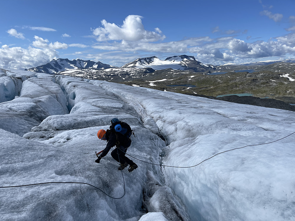 Små bakker er utfordrende nok når det er første dag på isbre. Flotte fjell i bakgrunnen!