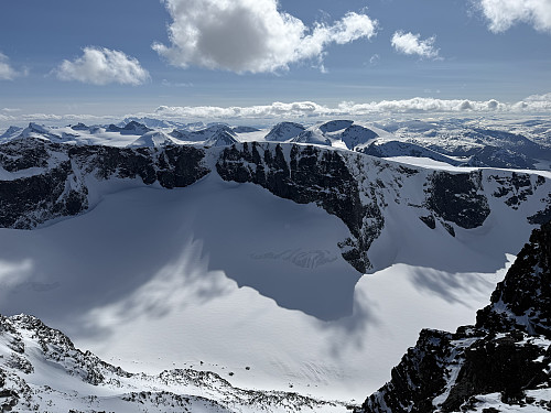 Fra Bakarste Storgrovhøe (2259 m) mot Heimre Illåbrean. Fjelltopper på Sognefjellet og Hurrungane ses i bakgrunnen.