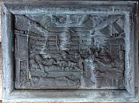 Wood carving showing seven Canadians in Botnahytto