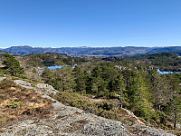 Ombolandskap med små vann og Hjelmeland i sør.