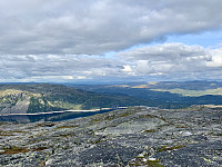 Utsikt mot nordøst. Vi ser Vatndalsvatnet med dammen i øst. Til høyre ser vi Geiskeli. Bak Svånuten, til venstre, ser vi Sæsnuten.