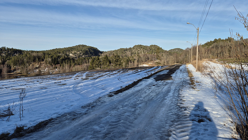 På grusveien i retning Torstein. Veien var mest bar, men hadde også partier med is og hard snø. Åsen bak til venstre er Middagsåsen (176). Cirka midt i bildet er Nilsås (163).