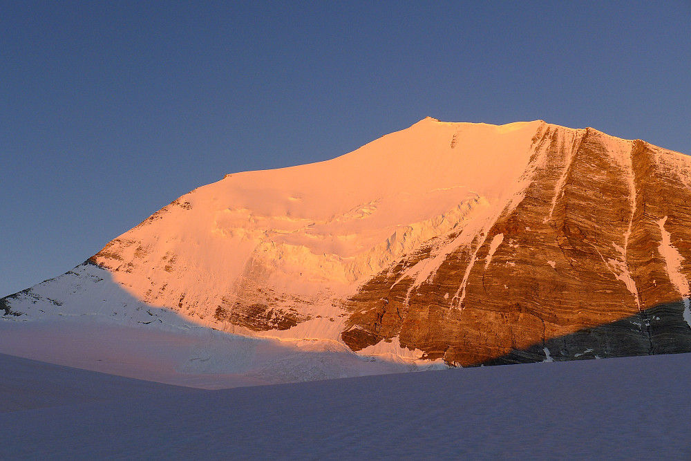 First rays of sunlight illuminating the northeast face of the Bishorn