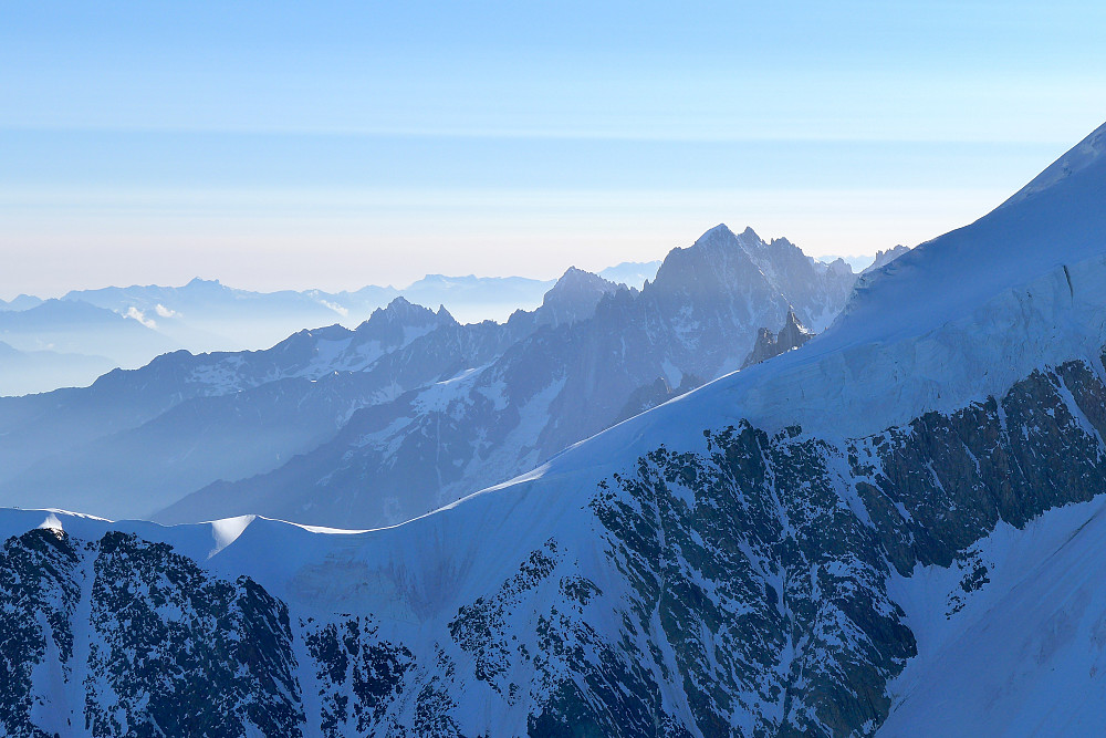 View towards the Gouter ridge (foreground) with the Cosmiques lift behind and Aiguille Verte in the background