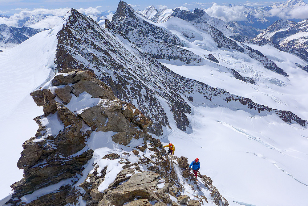 A pair of climbers on the ridge just below the summit