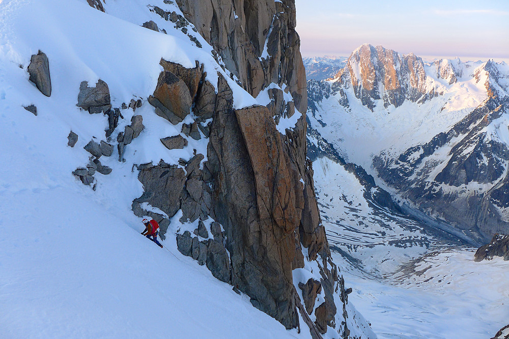A climber approaching the top of the couloir, seen from the ridge