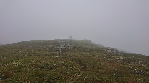 The large cairn appearing out of the fog