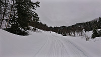 The snow-covered gravel road